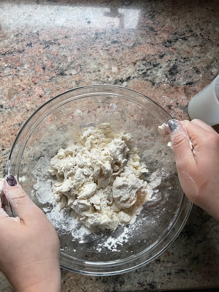 The dough should be able to just be held together when squeezed in the palm of your hand. Some dry bits remaining is OK!