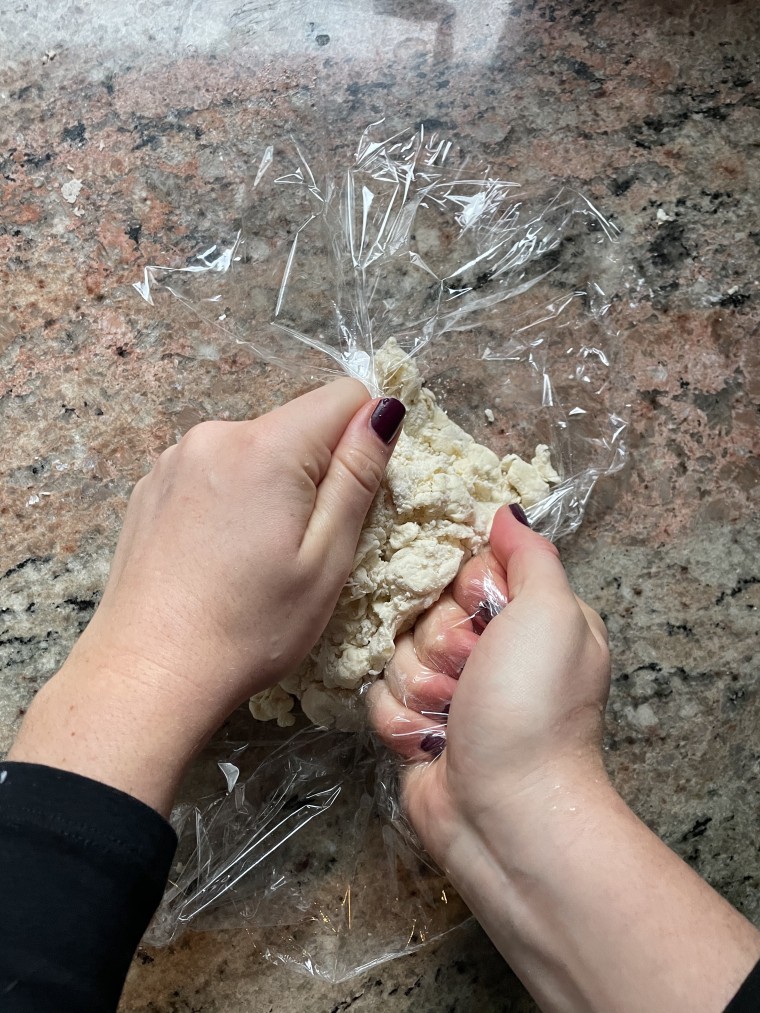 Use the plastic wrap to help bring dough together into one cohesive ball.
