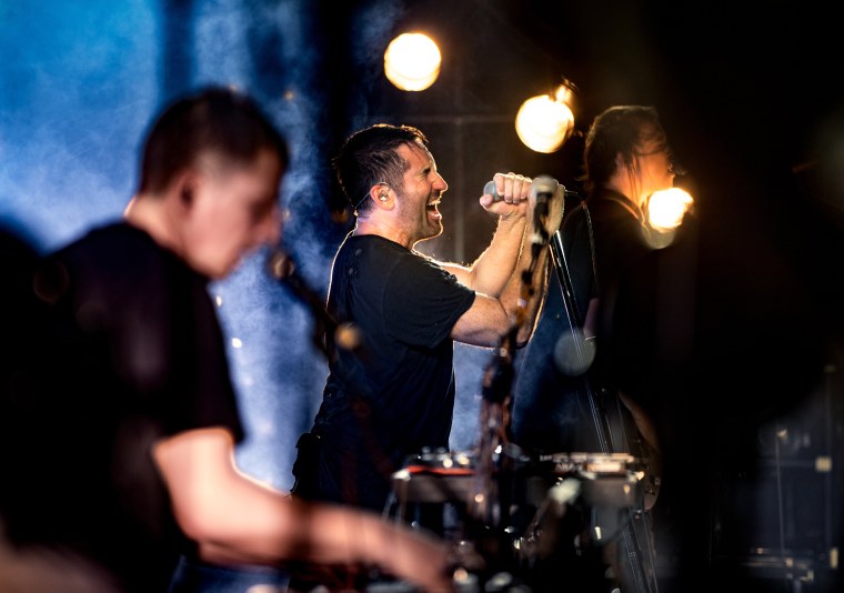 From left, Atticus Ross, Trent Reznor and Robin Finck of Nine Inch Nails perform onstage on July 23, 2017 in Los Angeles.