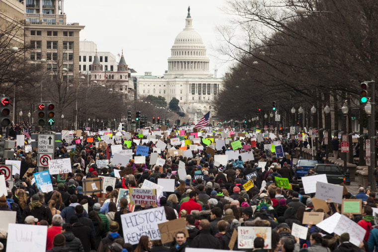 Image: Demonstrators march down Pennsylvania Avenue during a protest