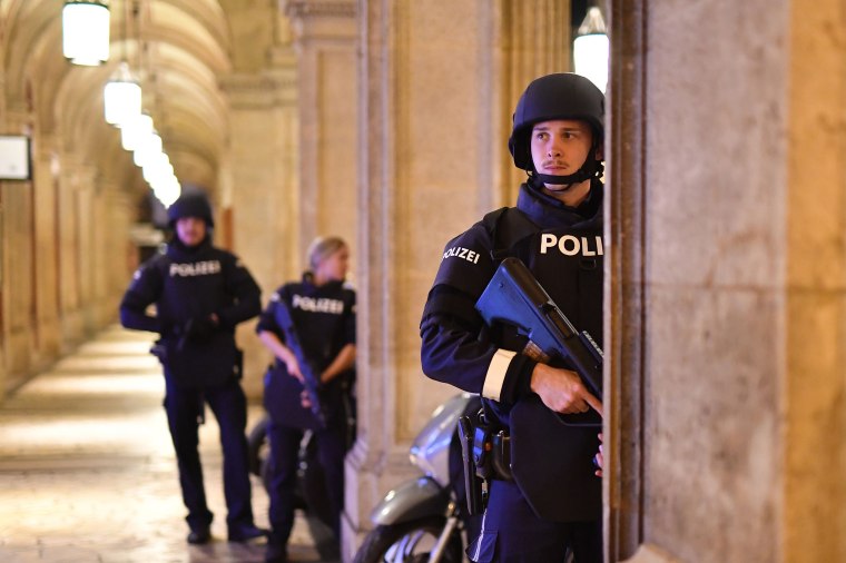 Image: Armed police patrol a passage near the opera in central Vienna