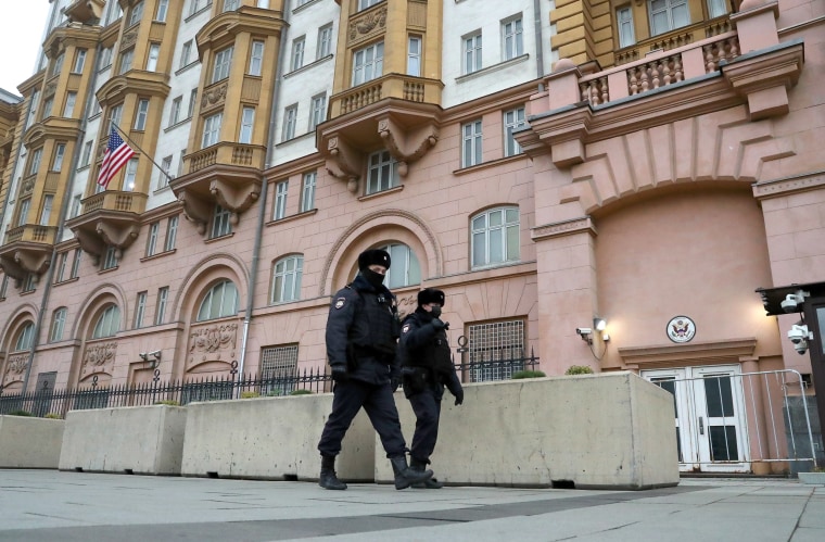 Image: Police officers walk past the U.S. Embassy in Moscow