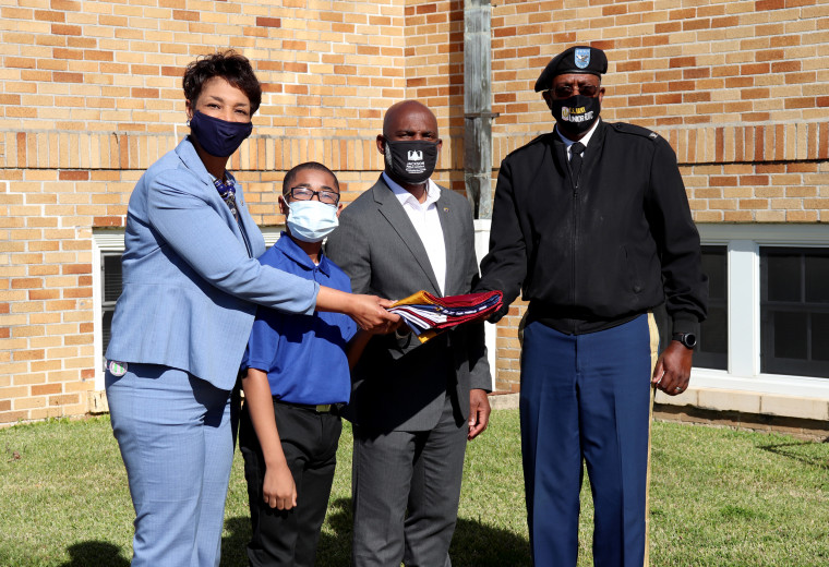 Image: LaShunna McInnis, principal of Powell Middle School, student Ethan Lott, Jackson Public Schools Superintendent Errick Greene and Col. Paul Willis, Director of junior ROTC for Jackson Public Schools attend a ceremony commemorating Mississippi voters