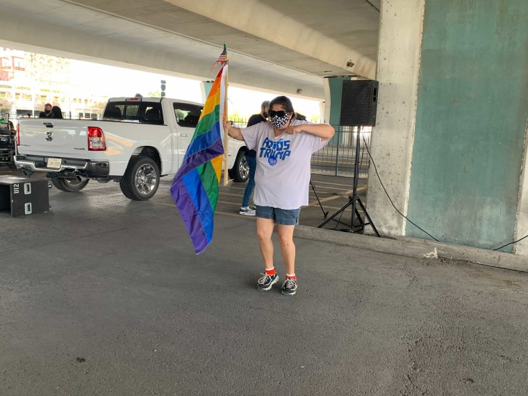 Molly Wright, 28, who is Mexican American and part of the LGBTQ community dances to Latin music as Joe Biden supporters gather at a parking lot in downtown San Antonio for a caravan celebrating Biden's win.