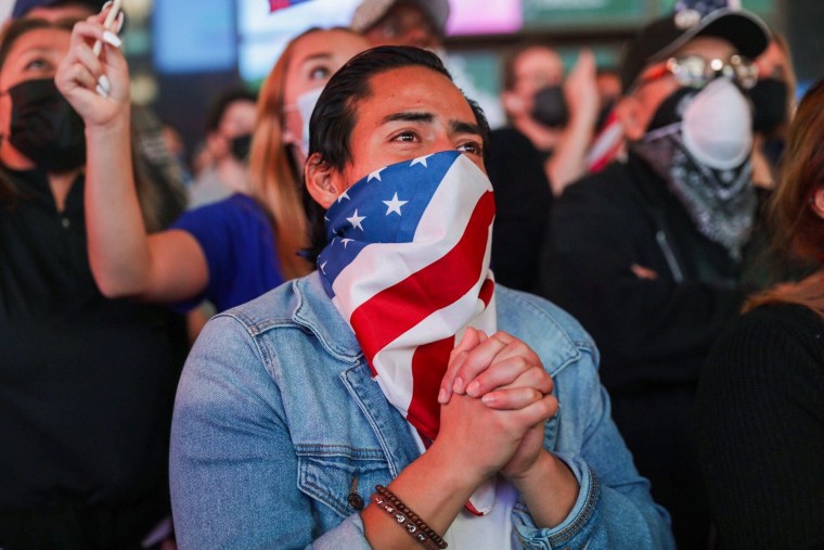 Supporters of president-elect Joe Biden watch his televised victory speech in Times Square.