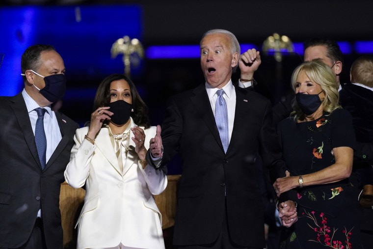 Image: JDoug Emhoff, Vice President-elect Kamala Harris, President-elect Joe Biden and Jill Biden react as confetti falls after Biden's speech to the nation in Wilmington, Del., on Saturday.