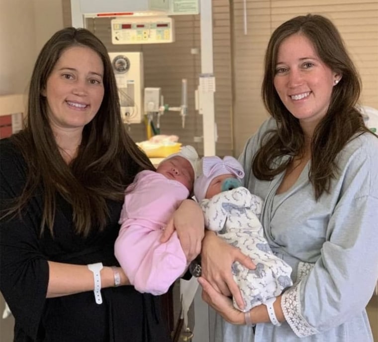 Autum Shaw cradled her daughter, Charleston, while Autum's twin sister Amber Tramontana posed with her daughter, Blakely.