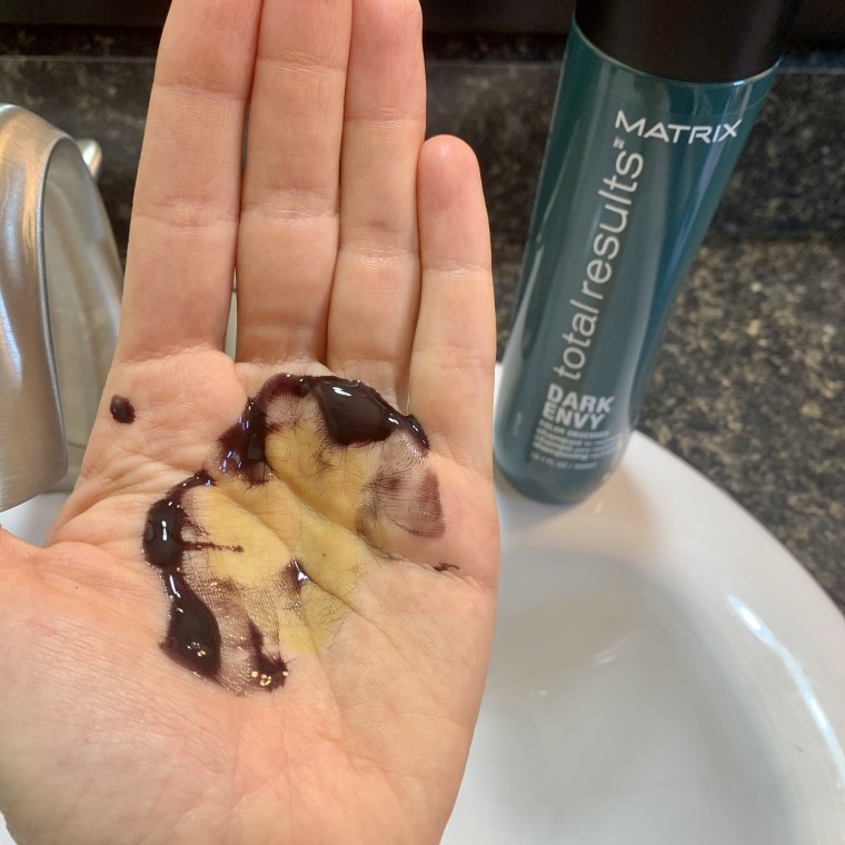 a yellow-green stain in my hand left behind from the shampoo