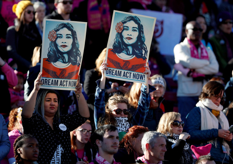 Image: Supporters of Deferred Action for Childhood Arrivals (DACA) hold signs during the Women's March rally in Las Vegas