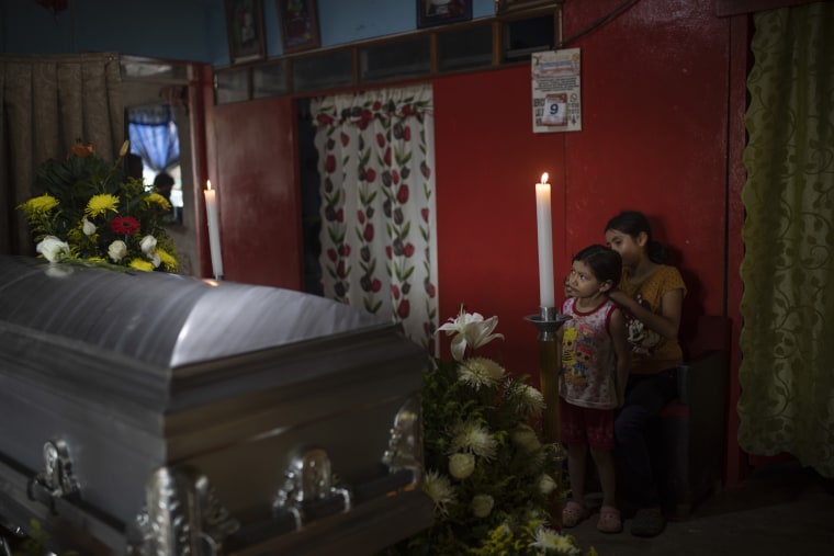 Two of of slain journalist Julio Valdivia's children stand by his casket during a wake inside their home in Tezonapa, Veracruz, Mexico, on Sept. 10, 2020.