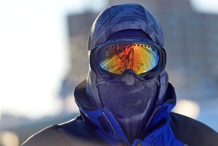 Image: Chris Griesmeyer dons ski goggles and a mask to protect him from the harsh wind chill