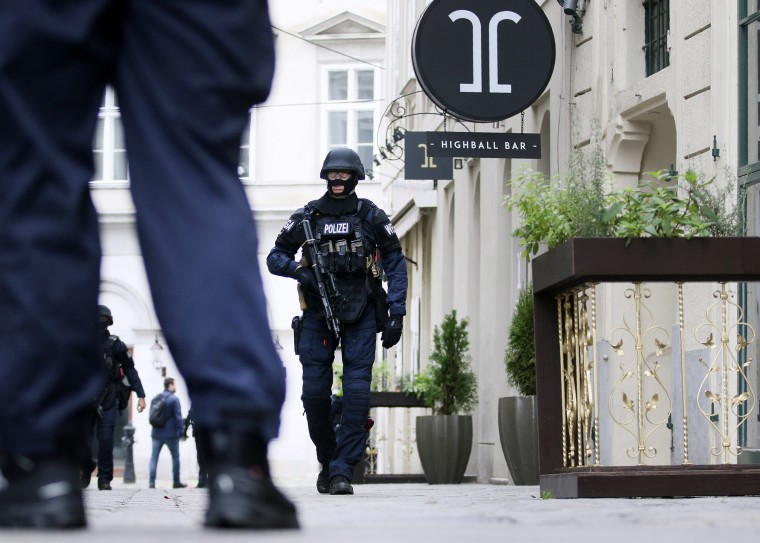Image: Armed police officers patrol the scene of a terror attack in Vienna, Austria