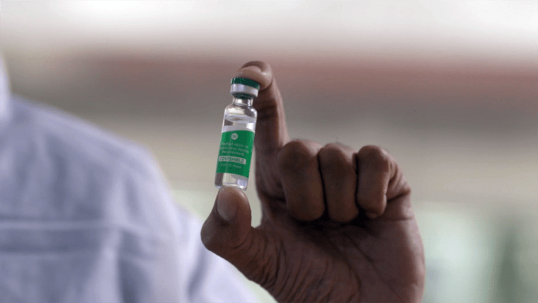 Image: A worker at the Serum Institute of India holding a vial of the Oxford Covid-19 vaccine candidate being produced under the name Covishield.