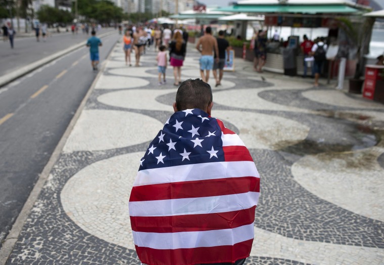 Image: A Brazilian man wears a U.S. flag in support of US President Donald Trump and his re-election on Copacabana beach in Rio de Janeiro, Brazil,