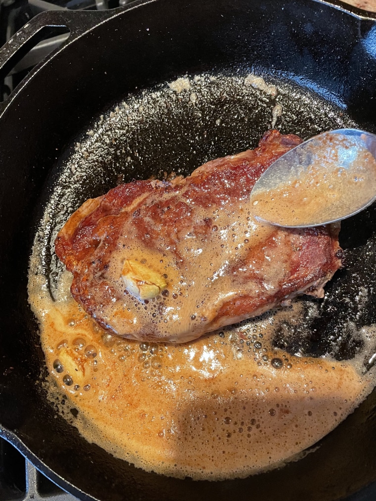 Slightly tilt your skillet towards you to pool the butter on one side to make basting the steak easier.