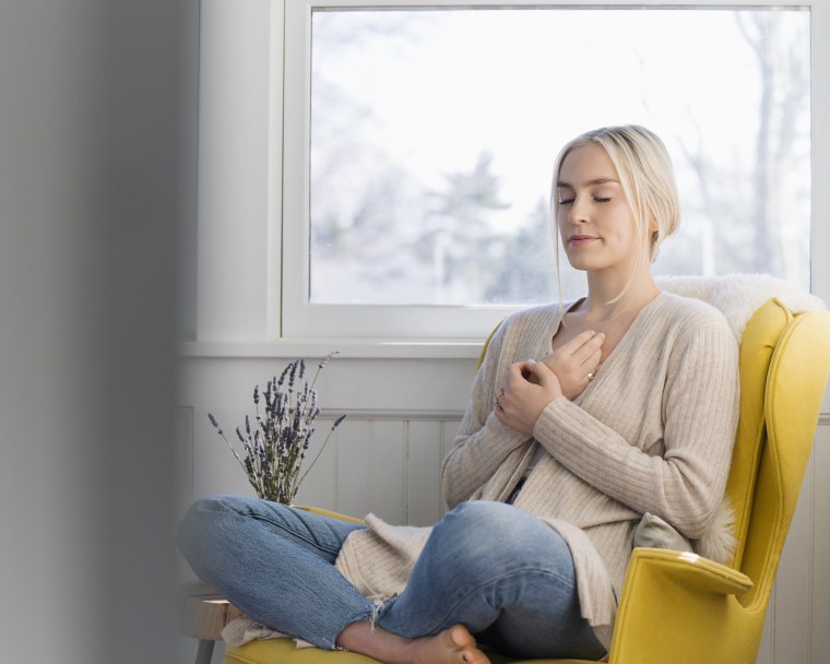 Image: Woman meditating at home