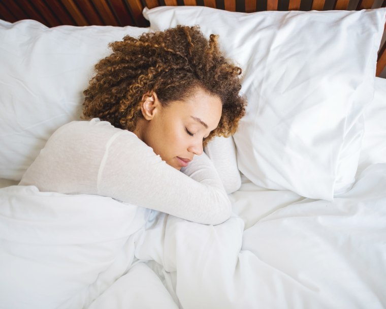 Image: African American woman sleeping in bed