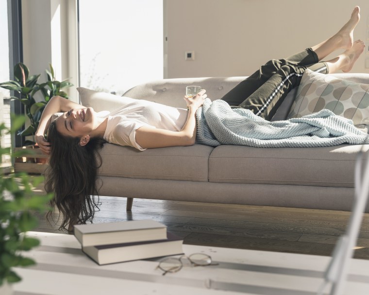 Image: Relaxed young woman lying on couch