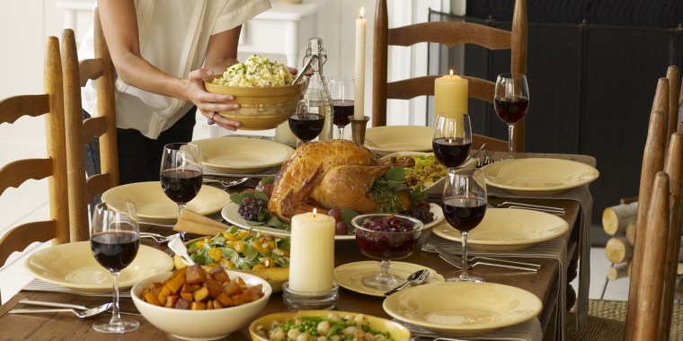 Woman setting table for Thanksgiving meal