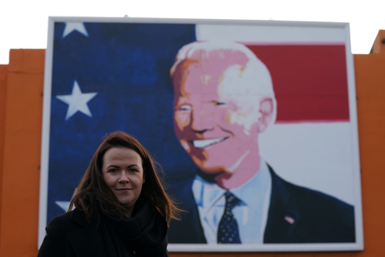 Image: Laurita Blewitt, who is a cousin of Democratic U.S. presidential nominee Joe Biden, poses in front of a Biden mural erected for the U.S. elections in the ancestral home of the Biden's in Ballina