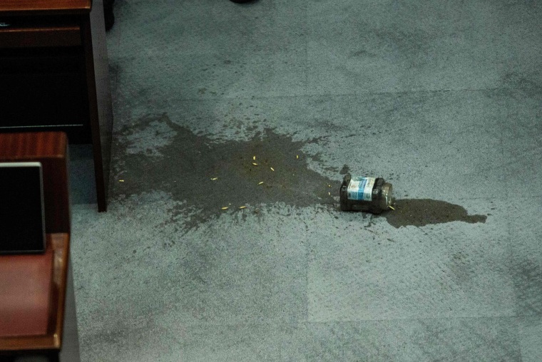 Image: A jar containing a foul-smelling liquid which was thrown by a pro-democracy lawmaker sits on the floor during a debate on a law that bans insulting China's national anthem, at a session of the Legislative Council (Legco) in Hong Kong