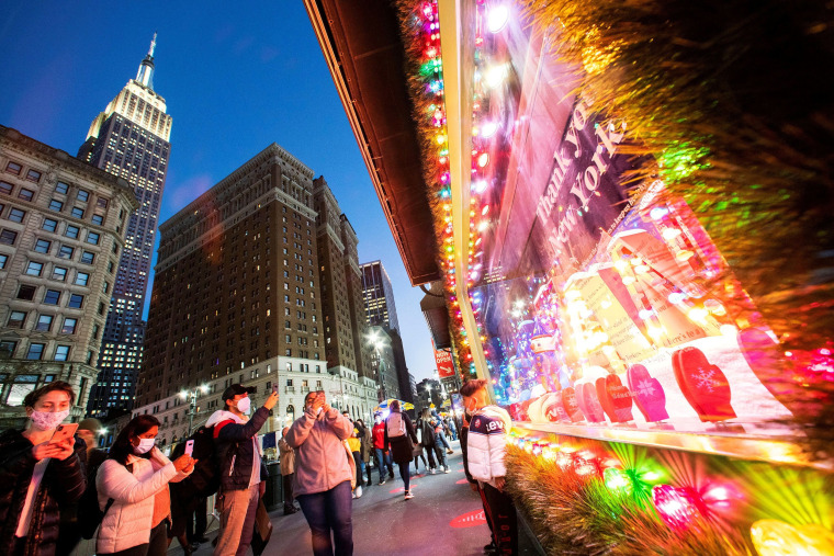 Image: People look at the Christmas window of the Macy's Herald Square store in New York City