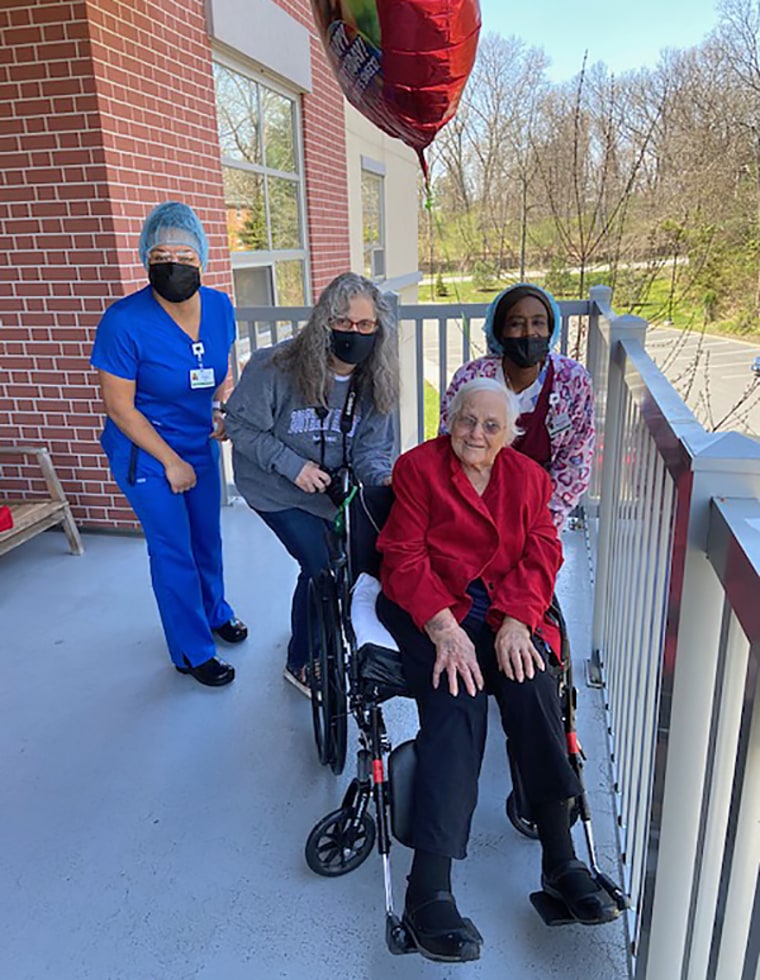 Staff members pose with a resident of Jewish Senior Services in Bridgeport, Conn.