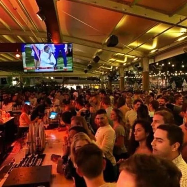 Patrons crowd around the bar at The Wharf Fort Lauderdale, in a photo verified by local officials, which announced on Sunday it would be temporarily shutting down.