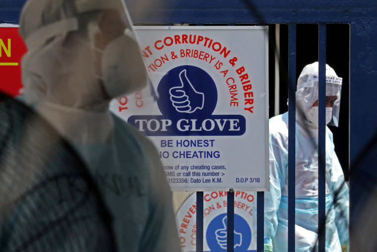 Image: Medical workers at a Top Glove hostel under enhanced lockdown in Klang, Malaysia