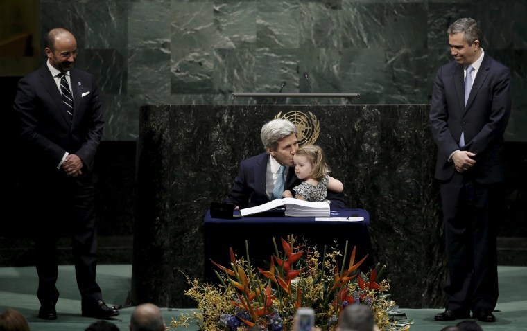 Image: Secretary of State John Kerry kisses his two-year-old granddaughter after signing the Paris Agreement on climate change at United Nations. 