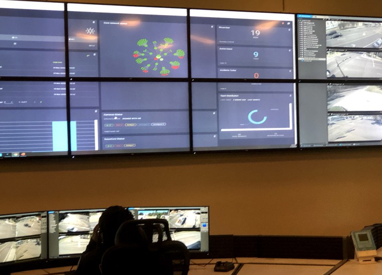 Image: An officer with the Jackson Police Department monitors live feeds from security cameras posted across the city at the city's new real time command center on Nov. 19, 2020.