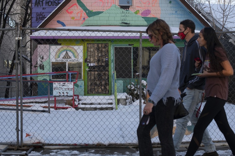 Image: People walk by the "Wana Art House" on Tennyson Street, in Denver