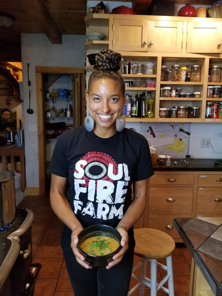 Leah Penniman of Soul Fire Farm holds a bowl of soup joumou.