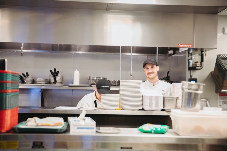 Fine-Drawn Hospitality’s executive Chef Jack Peterson (right) prepares The Commons menu along with his staff.