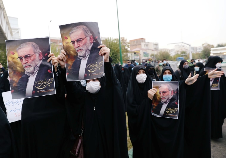 Image: Protesters hold the pictures of Iran's top nuclear scientist during a demonstration against his killing in Tehran on Saturday.