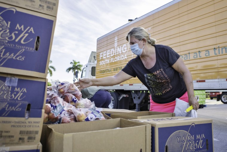 Volunteers preparing food at a food distribution at the West Palm Beach Outlets in West Palm Beach, Florida on 7/21/2020.