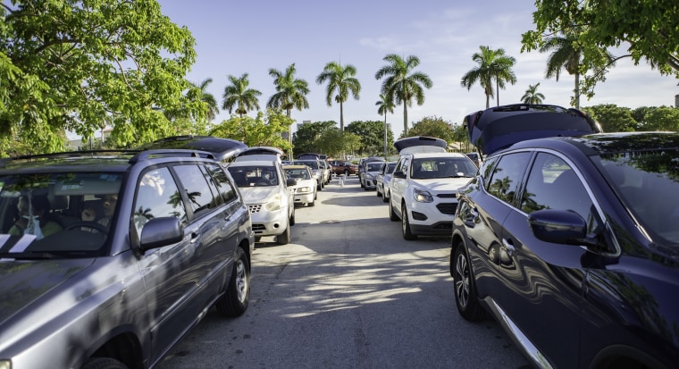 Cars lined up to receive food at a food distribution at Palm Beach Outlets in West Palm Beach, Florida on 7/21/2020