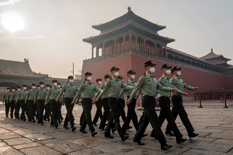 Image: People's Liberation Army soldiers march next to the entrance to the Forbidden City during the opening ceremony of the Chinese People's Political Consultative Conference in Beijing