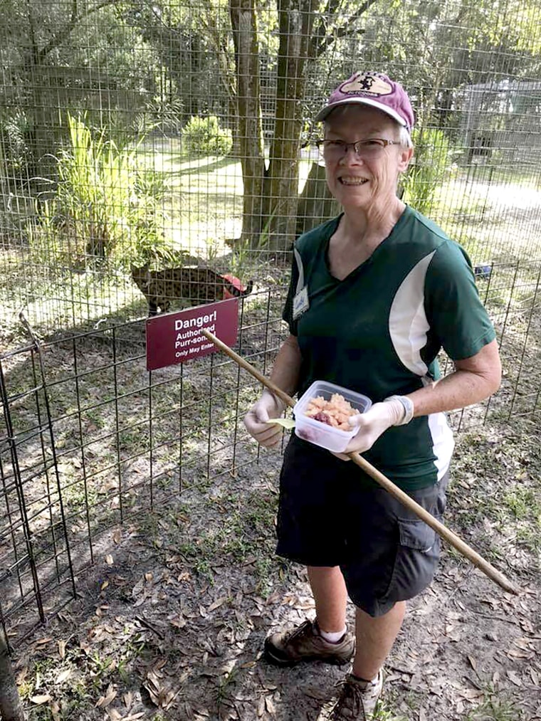 Volunteer Candy Couser smiles before feeding big cats at Carole Baskin's Big Cat Rescue sanctuary near Tampa, Fla. in 2018. Couser, who regularly feeds big cats was bitten and seriously injured by a tiger Thursday morning, Dec. 3, 2020, at the sanctuary, which was made famous by the Netflix series "Tiger King," officials said.