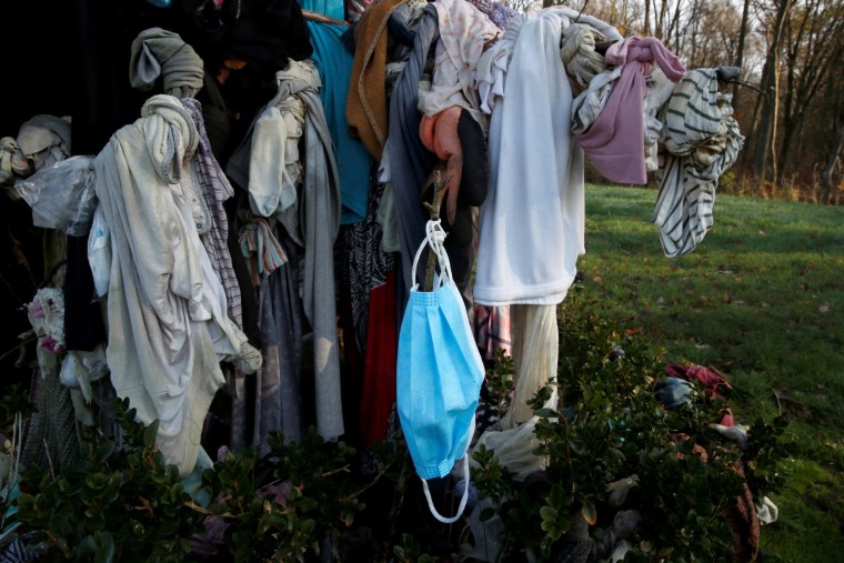 Image: Masks hang on trees in northern France to banish COVID-19