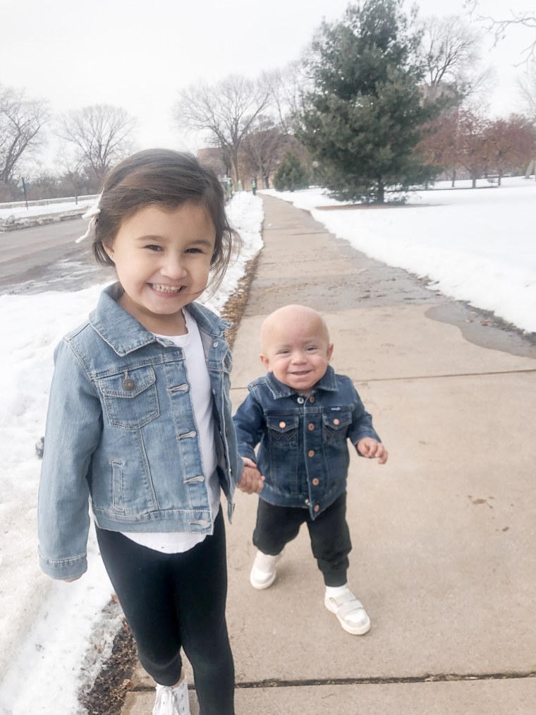 Olivia Vasquez holds her brother's hand during their stay in Minneapolis, Minnesota, last year where baby Eli received bone marrow donated by his sister. He lost his hair and suffered other side effects from chemotherapy necessary before the transplant.