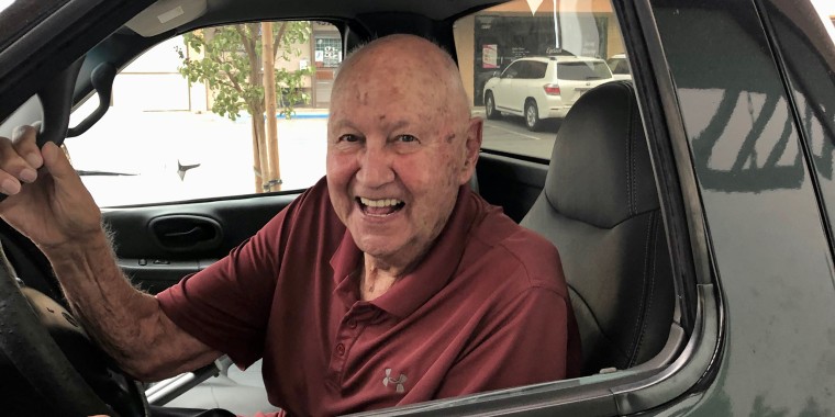 Walker laughs on one his daily runs to Dunkin' at the drive-thru. The staff knows to expect him to show up around 9:30 a.m. each morning and if he doesn't, send someone to check on him and Virginia.
