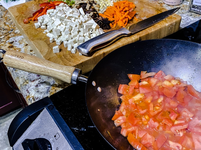 The soup's flavorful base gets its start with diced tomatoes sautéed in corn oil.