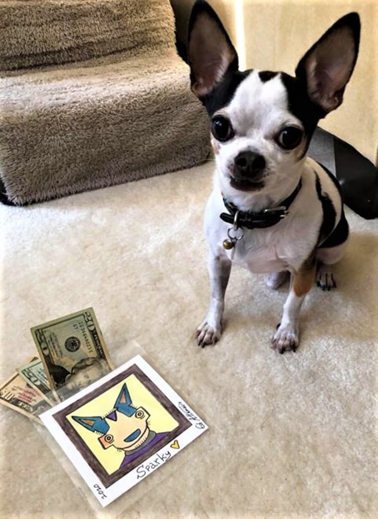 Sparky poses with a portrait and a donation.