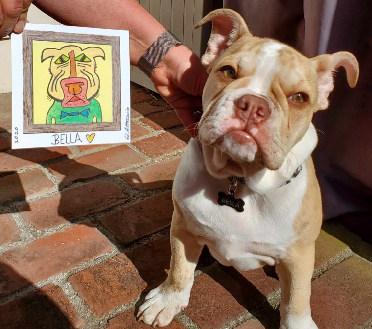 Bella smiles with her portrait.