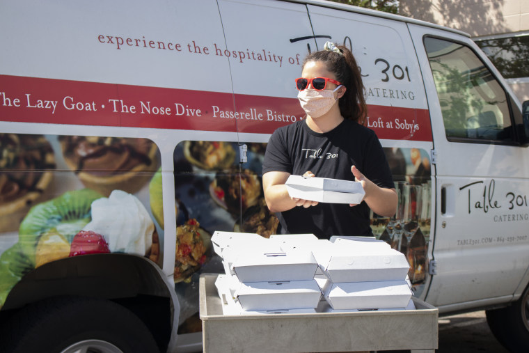 A Table 301 Catering employee delivers meals to Project Host, a soup kitchen in Greenville, South Carolina.