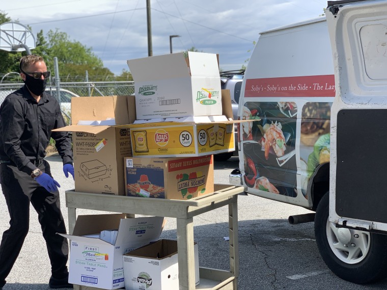 A Table 301 Catering employee delivers meals to Project Host, a soup kitchen in Greenville, South Carolina.