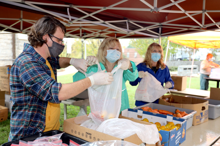 Pastor Susan Crowell hands out meals at Trinity Lutheran church in Greenville, South Carolina.