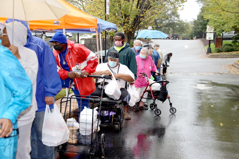 People line up to receive meals at Trinity Lutheran church in Greenville, South Carolina.