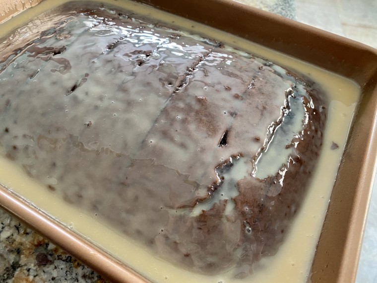 Caramel topping and sweetened condensed milk get heated on a stovetop then poured over the cake.